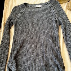 Woman’s ribbed grey sweater